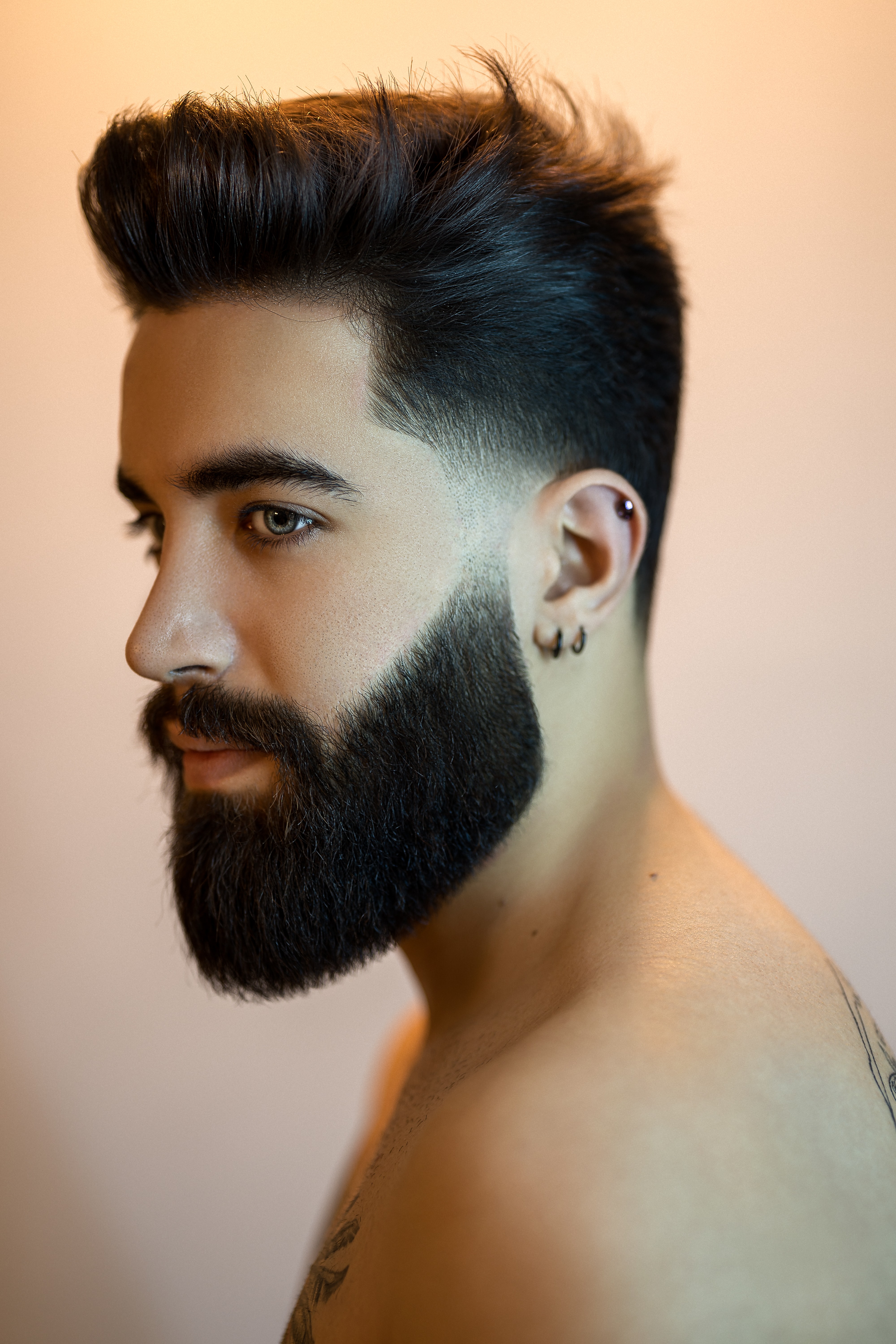 man with dark neat hair and beard